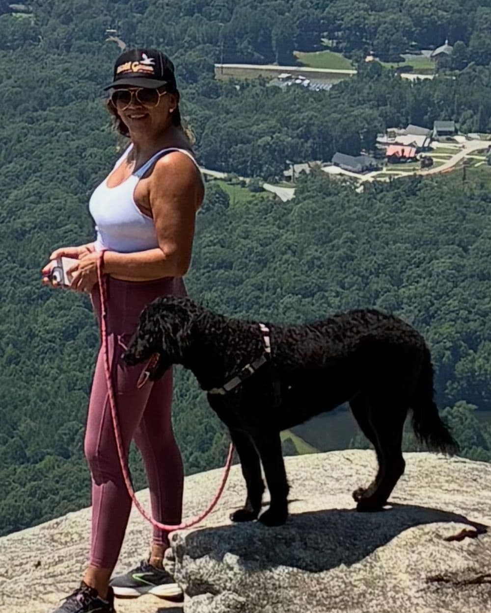 Angelica Rios hiking with her dog at a mountain overlook in Georgia